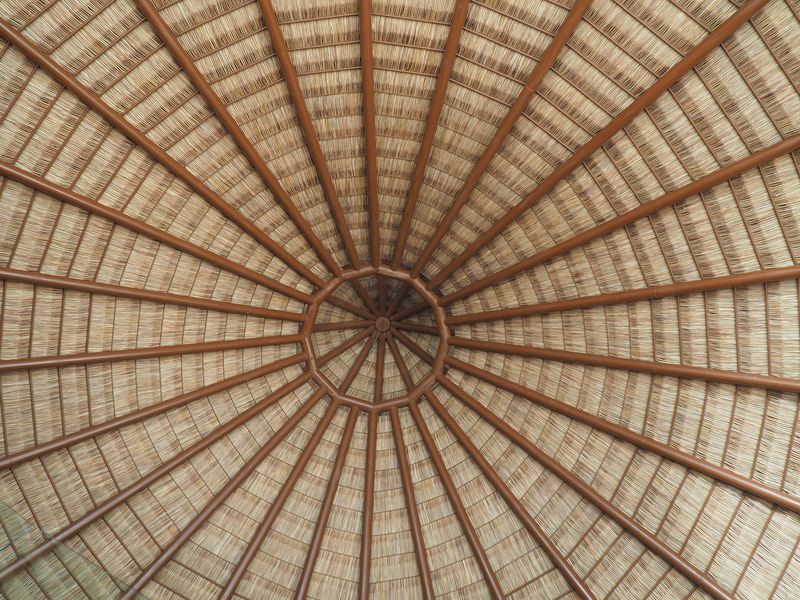 Looking up at the inside of the thatched roof of the restaurant